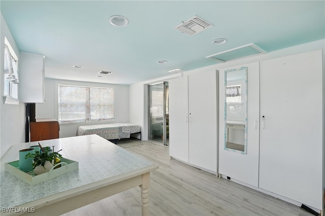 4011 Coconut Cir S, Naples, FL 34104 - kitchen with light wood-style flooring, recessed lighting, white cabinetry, and light countertops