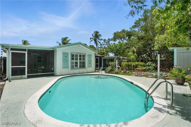 4011 Coconut Cir S, Naples, FL 34104 - outdoor pool with a sunroom, a patio area, and a ceiling fan