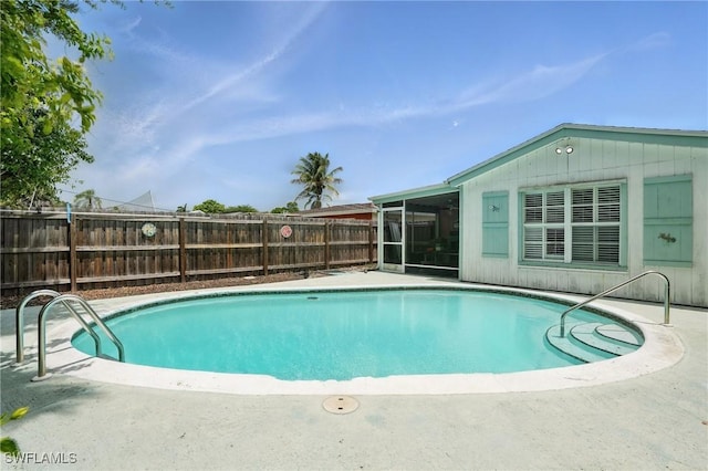 4011 Coconut Cir S, Naples, FL 34104 - view of swimming pool with a sunroom and a fenced backyard