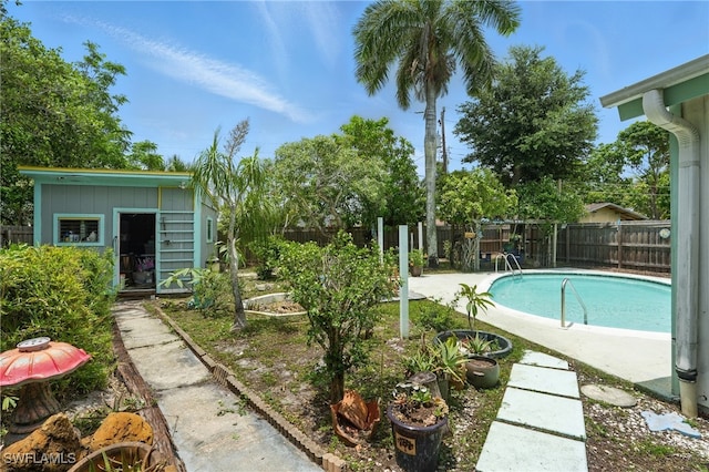 4011 Coconut Cir S, Naples, FL 34104 - view of pool featuring a fenced backyard and an outdoor structure