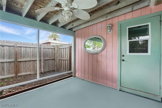 4011 Coconut Cir S, Naples, FL 34104 - unfurnished sunroom with a ceiling fan and beamed ceiling
