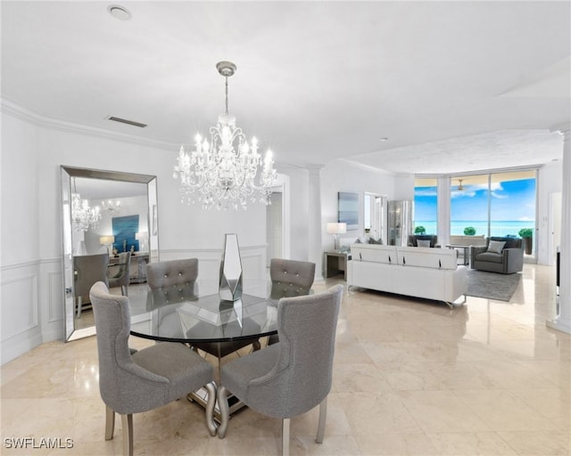 7117 Pelican Bay Blvd Unit 1903, Naples, FL 34108 - dining area featuring a chandelier, ornamental molding, ornate columns, a decorative wall, and floor to ceiling windows