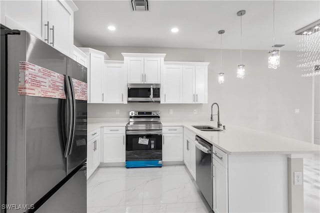 210 Aurora Ave S, Lehigh Acres, FL 33974 - kitchen featuring stainless steel appliances, a peninsula, light marble finish flooring, light countertops, and white cabinetry