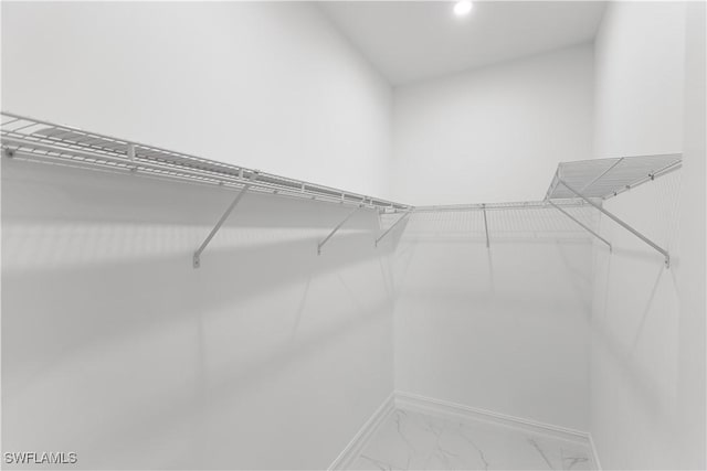 210 Aurora Ave S, Lehigh Acres, FL 33974 - spacious closet featuring marble look tile flooring