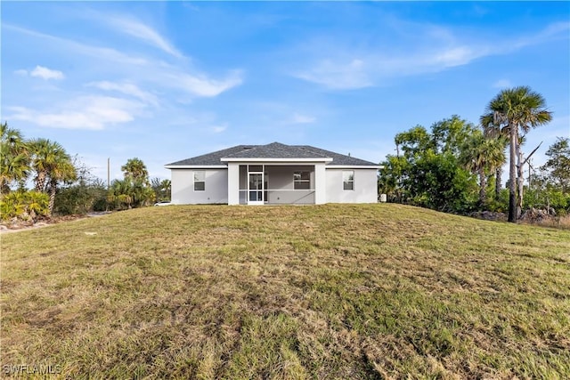 210 Aurora Ave S, Lehigh Acres, FL 33974 - rear view of house with a lawn, a sunroom, and stucco siding
