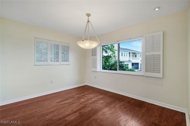 4160 Crayton Rd Unit A8, Naples, FL 34103 - spare room featuring baseboards and wood finished floors