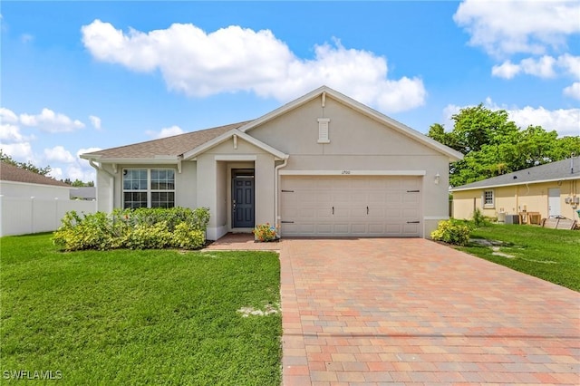 1700 SW 3rd St, Cape Coral, FL 33991 - ranch-style house with stucco siding, decorative driveway, and a garage