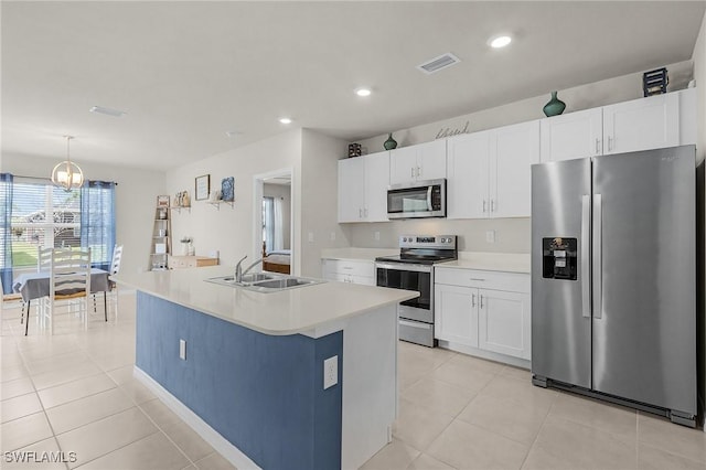 1700 SW 3rd St, Cape Coral, FL 33991 - kitchen featuring stainless steel appliances, white cabinets, light tile patterned floors, light countertops, and recessed lighting