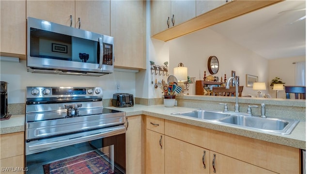 1133 Van Loon Commons Cir Unit 202, Cape Coral, FL 33909 - kitchen with appliances with stainless steel finishes, light brown cabinetry, light countertops, and tile patterned floors