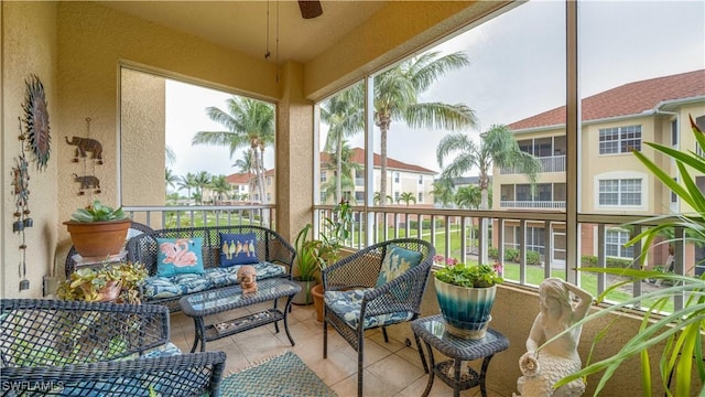 1133 Van Loon Commons Cir Unit 202, Cape Coral, FL 33909 - sunroom / solarium with an outdoor hangout area, tile patterned floors, a ceiling fan, a textured wall, and plenty of natural light