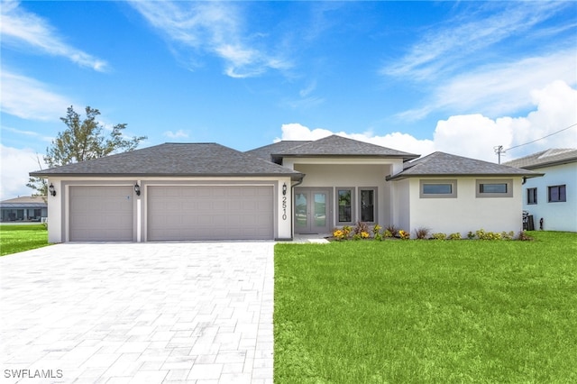 2510 SW 17th Ave, Cape Coral, FL 33914 - prairie-style home with an attached garage, stucco siding, decorative driveway, a front lawn, and french doors