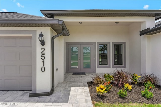 2510 SW 17th Ave, Cape Coral, FL 33914 - view of exterior entry featuring french doors, stucco siding, and an attached garage