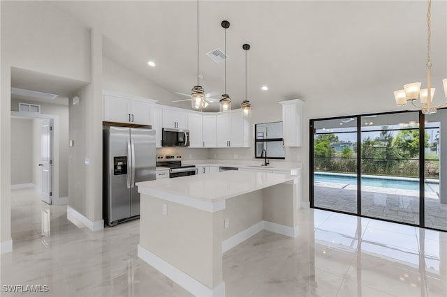 2510 SW 17th Ave, Cape Coral, FL 33914 - kitchen featuring stainless steel appliances, a center island, a ceiling fan, light countertops, and white cabinetry
