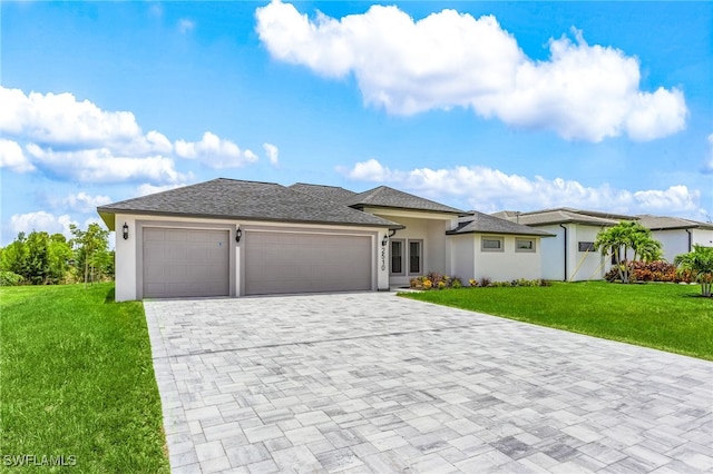 2510 SW 17th Ave, Cape Coral, FL 33914 - prairie-style house featuring decorative driveway, an attached garage, a front yard, and stucco siding