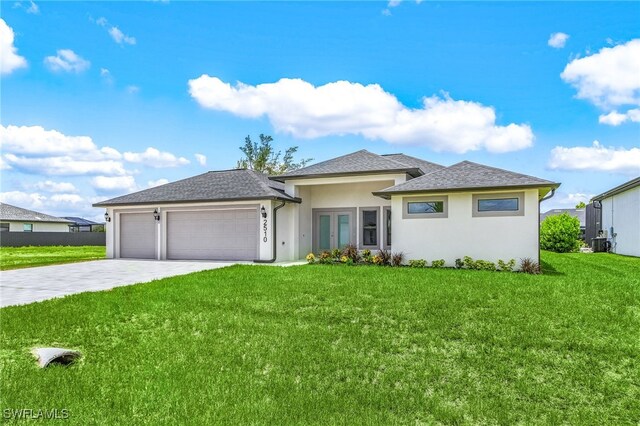 2510 SW 17th Ave, Cape Coral, FL 33914 - prairie-style home with an attached garage, stucco siding, driveway, a front lawn, and french doors