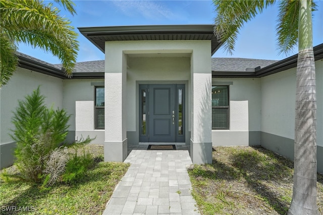 1028 NW 33rd Ave, Cape Coral, FL 33993 - entrance to property featuring stucco siding and roof with shingles
