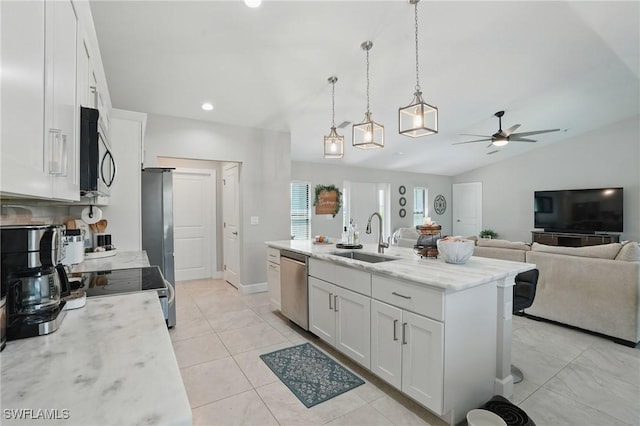 1028 NW 33rd Ave, Cape Coral, FL 33993 - kitchen with appliances with stainless steel finishes, a ceiling fan, white cabinets, an island with sink, and vaulted ceiling
