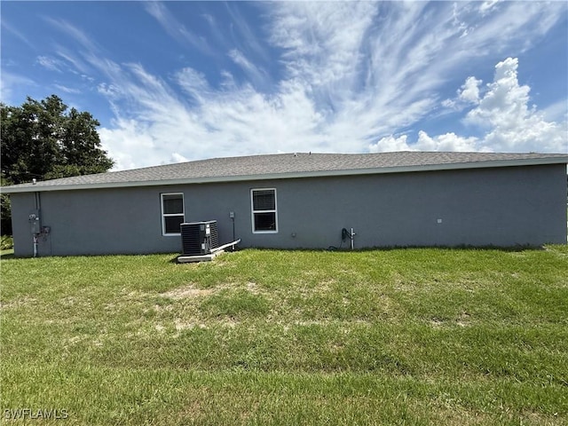 2343 Briarwood St, Punta Gorda, FL 33980 - rear view of house with stucco siding and a lawn