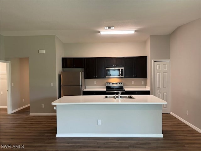 2343 Briarwood St, Punta Gorda, FL 33980 - kitchen with appliances with stainless steel finishes, dark wood-type flooring, light countertops, and a center island with sink