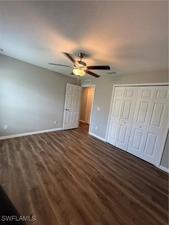 2343 Briarwood St, Punta Gorda, FL 33980 - unfurnished bedroom with dark wood-style flooring, a closet, and a ceiling fan