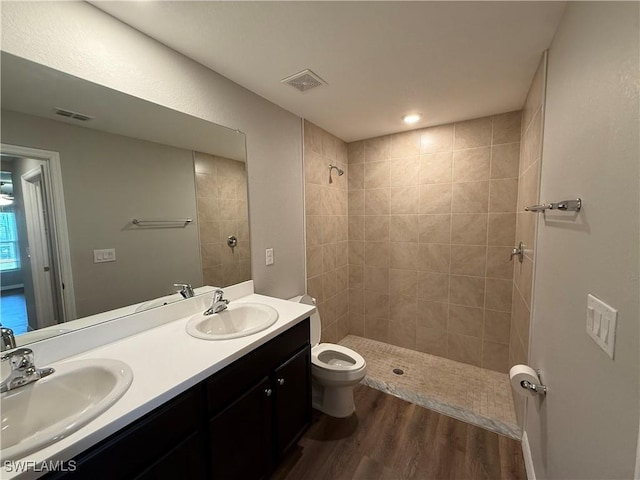 2343 Briarwood St, Punta Gorda, FL 33980 - bathroom with double vanity, a tile shower, and wood finished floors