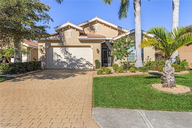 20571 Long Pond Rd, North Fort Myers, FL 33917 - mediterranean / spanish house with decorative driveway, stucco siding, an attached garage, a front yard, and a tile roof