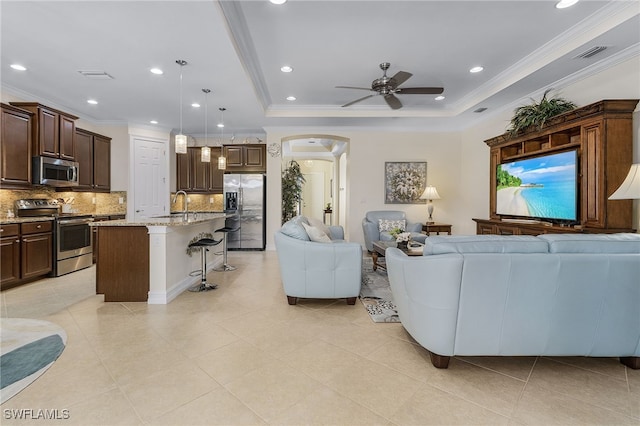 20571 Long Pond Rd, North Fort Myers, FL 33917 - living area featuring arched walkways, ceiling fan, crown molding, recessed lighting, and a tray ceiling