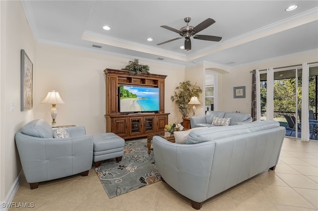 20571 Long Pond Rd, North Fort Myers, FL 33917 - living room featuring light tile patterned flooring, a ceiling fan, a raised ceiling, crown molding, and arched walkways