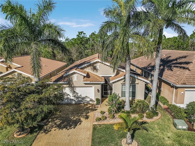 20571 Long Pond Rd, North Fort Myers, FL 33917 - view of front of house featuring stucco siding, a garage, decorative driveway, and a tile roof