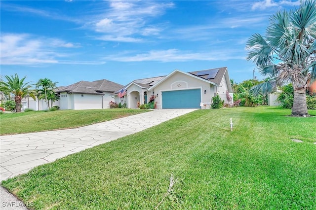2127 SW 49th Ter, Cape Coral, FL 33914 - ranch-style home featuring an attached garage, roof mounted solar panels, a front yard, driveway, and stucco siding