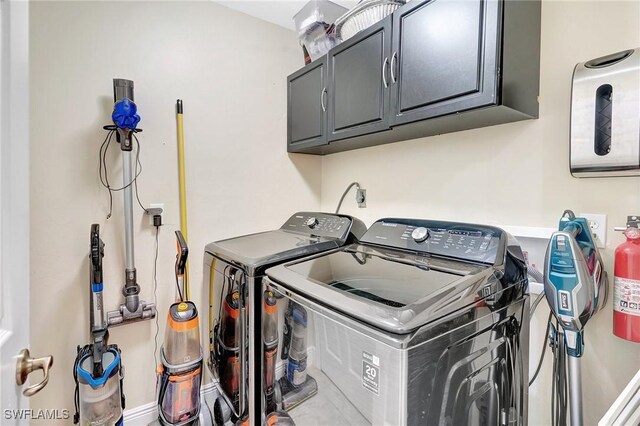 2127 SW 49th Ter, Cape Coral, FL 33914 - laundry room featuring cabinet space and independent washer and dryer