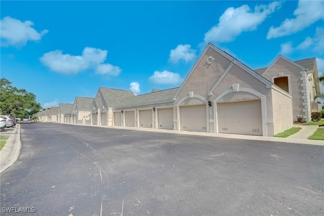 12170 Kelly Greens Blvd Unit 88, Fort Myers, FL 33908 - view of front of home featuring community garages