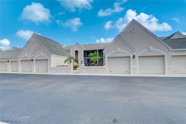 12170 Kelly Greens Blvd Unit 88, Fort Myers, FL 33908 - view of front of property with community garages and stucco siding