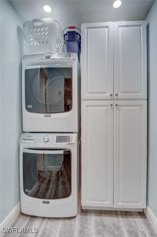 12170 Kelly Greens Blvd Unit 88, Fort Myers, FL 33908 - washroom featuring stacked washer / drying machine and cabinet space