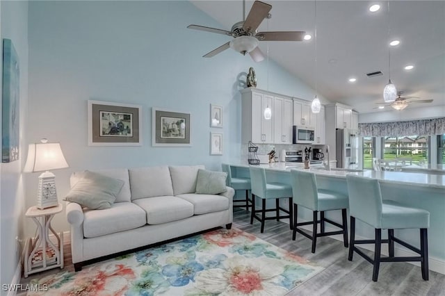 12170 Kelly Greens Blvd Unit 88, Fort Myers, FL 33908 - living room featuring a ceiling fan, light wood finished floors, recessed lighting, and high vaulted ceiling