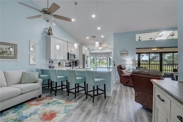 12170 Kelly Greens Blvd Unit 88, Fort Myers, FL 33908 - living room featuring a ceiling fan, light wood finished floors, high vaulted ceiling, and recessed lighting