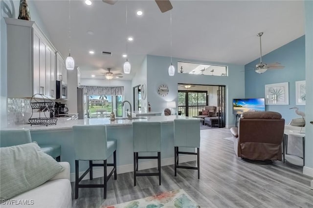 12170 Kelly Greens Blvd Unit 88, Fort Myers, FL 33908 - kitchen featuring ceiling fan, appliances with stainless steel finishes, high vaulted ceiling, a peninsula, and open floor plan