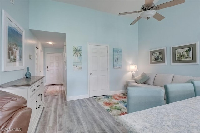 12170 Kelly Greens Blvd Unit 88, Fort Myers, FL 33908 - living room with a high ceiling, light wood-type flooring, and a ceiling fan