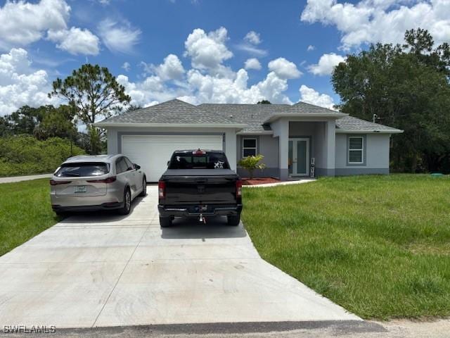406 W 15th St, Lehigh Acres, FL 33972 - view of front of property with concrete driveway, a front yard, an attached garage, and stucco siding