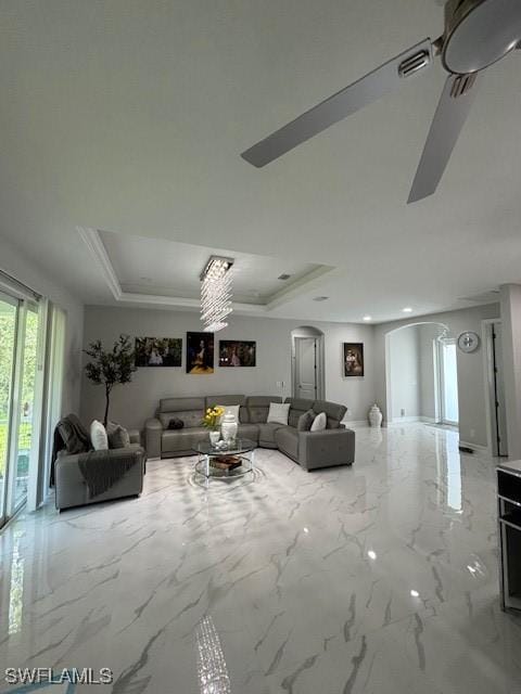 406 W 15th St, Lehigh Acres, FL 33972 - living room featuring arched walkways, a tray ceiling, a ceiling fan, marble finish floors, and recessed lighting