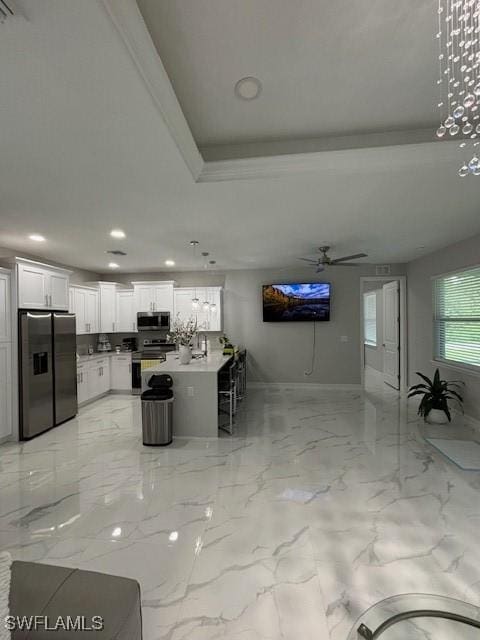 406 W 15th St, Lehigh Acres, FL 33972 - kitchen with appliances with stainless steel finishes, white cabinets, a raised ceiling, a ceiling fan, and recessed lighting