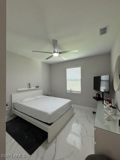406 W 15th St, Lehigh Acres, FL 33972 - bedroom with light marble finish floors and a ceiling fan