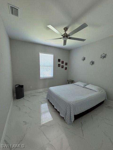 406 W 15th St, Lehigh Acres, FL 33972 - bedroom with light marble finish flooring and a ceiling fan