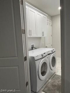 406 W 15th St, Lehigh Acres, FL 33972 - laundry area featuring washer and dryer and cabinet space