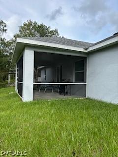 406 W 15th St, Lehigh Acres, FL 33972 - view of outdoor structure featuring a sunroom