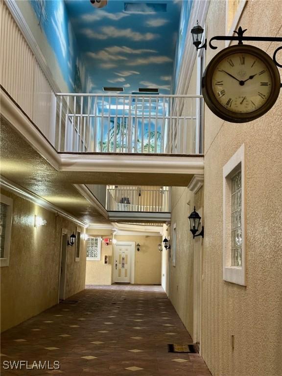 12505 Mcgregor Blvd Unit 204B, Fort Myers, FL 33919 - hallway with a high ceiling, crown molding, and wood finished floors
