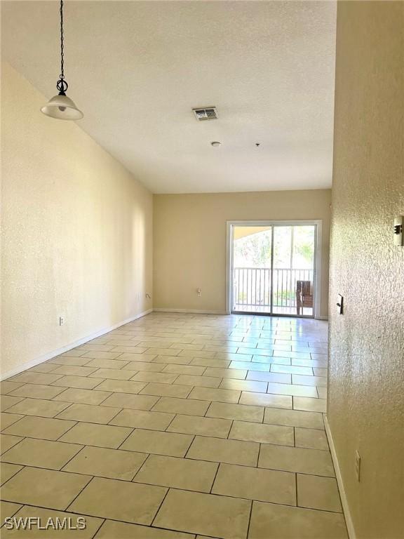 12505 Mcgregor Blvd Unit 204B, Fort Myers, FL 33919 - empty room with baseboards and light tile patterned floors
