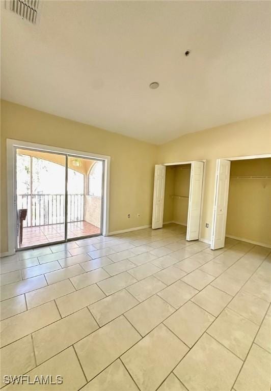 12505 Mcgregor Blvd Unit 204B, Fort Myers, FL 33919 - unfurnished room with light tile patterned floors and vaulted ceiling
