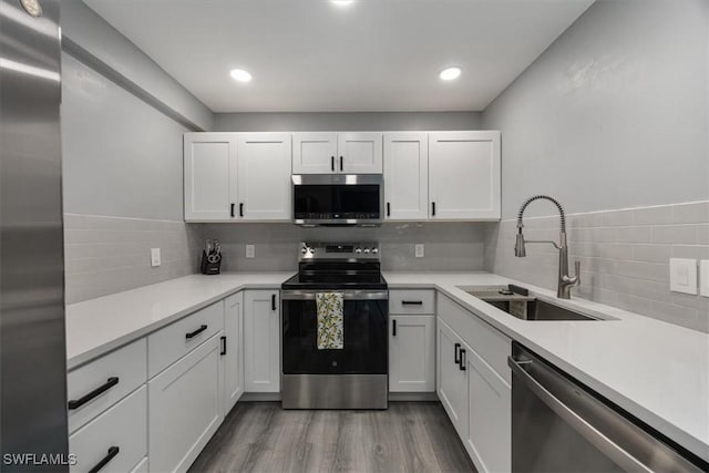 13405 Fox Chapel Ct, Fort Myers, FL 33919 - kitchen featuring stainless steel appliances, white cabinetry, light countertops, and recessed lighting