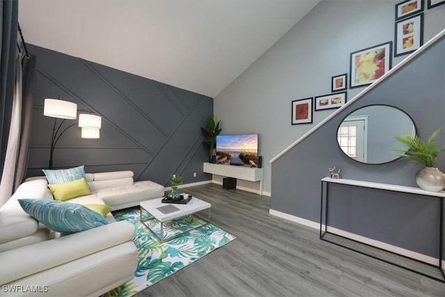 13405 Fox Chapel Ct, Fort Myers, FL 33919 - living area featuring wood finished floors, high vaulted ceiling, and a decorative wall